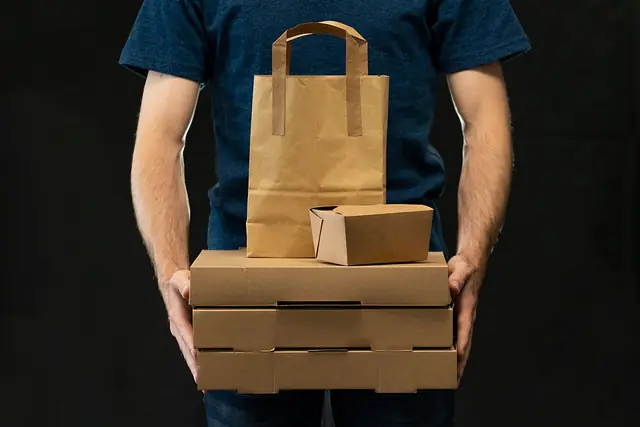 A man carrying takeaway delivery packages